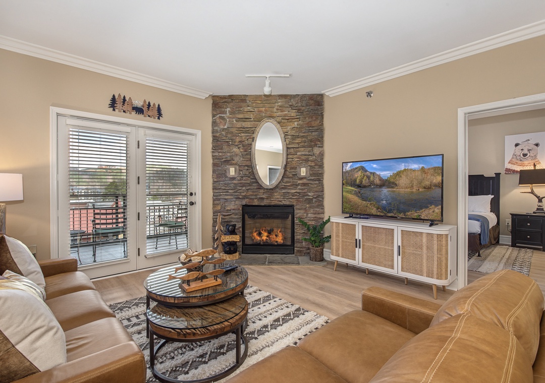 Unwind in your cozy living room with crackling fireplace, plush leather seating, and stunning mountain views on the big screen TV.