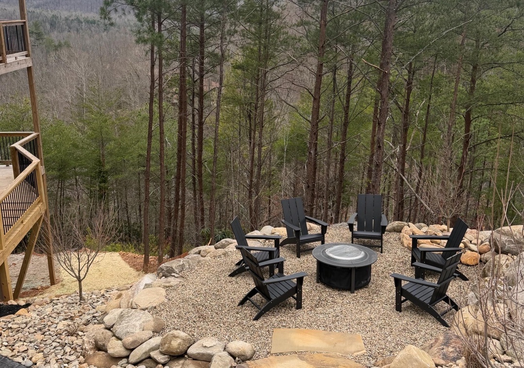 Gather around your private fire pit surrounded by Adirondack chairs, where mountain views and forest serenity create the perfect evening retreat.