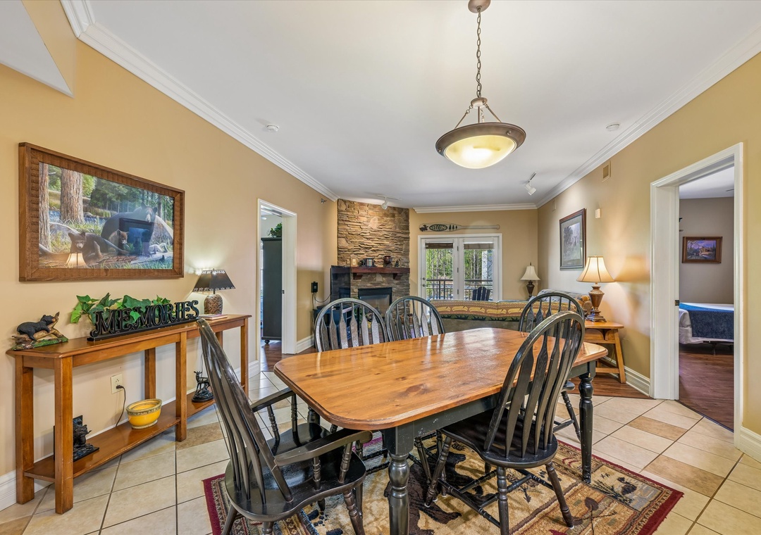 Gather around your rustic dining table for memorable meals, with a cozy stone fireplace creating the perfect ambiance for intimate conversations.