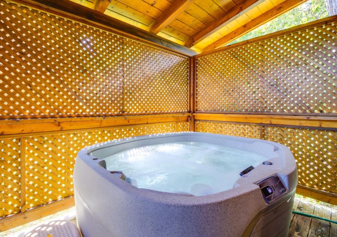 Slip into your private hot tub sanctuary, where warm bubbles and filtered sunlight create the perfect escape.