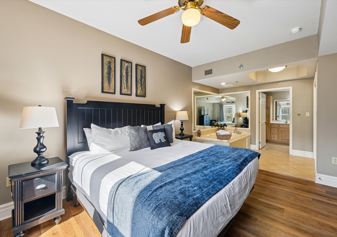 Unwind in your elegant bedroom featuring a plush king bed, hardwood floors, and open layout connecting to your kitchen.