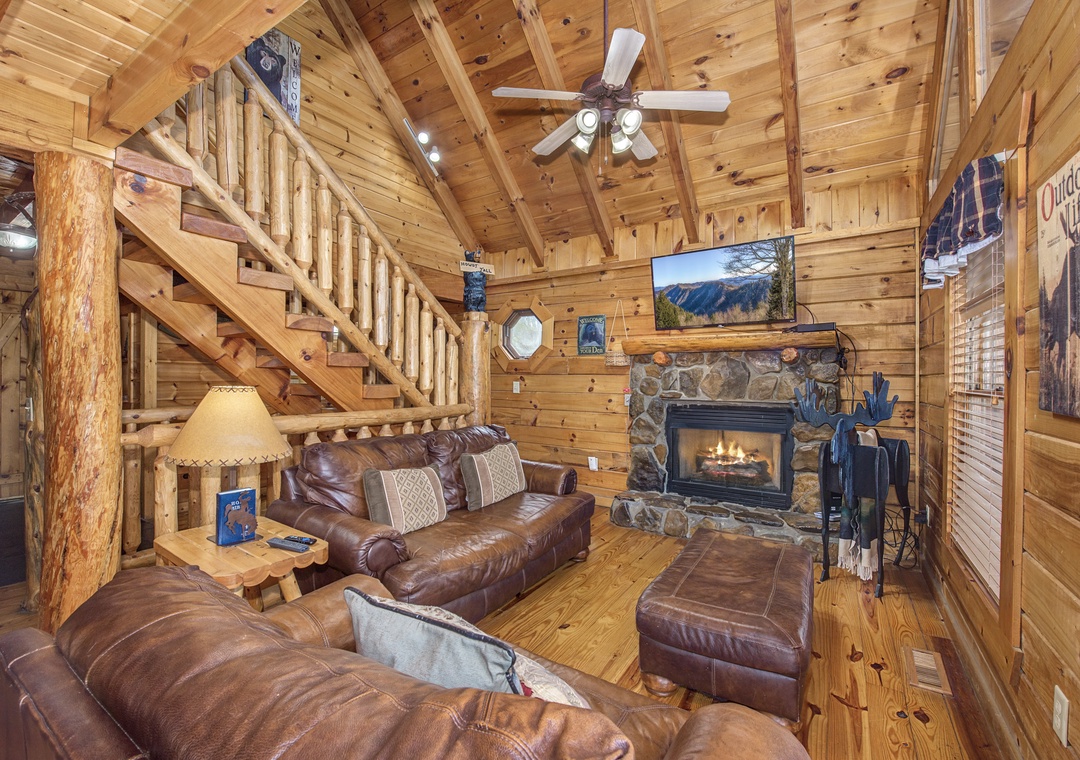 Sink into plush leather seating by your crackling stone fireplace, where rustic wood beams frame cozy mountain evenings.