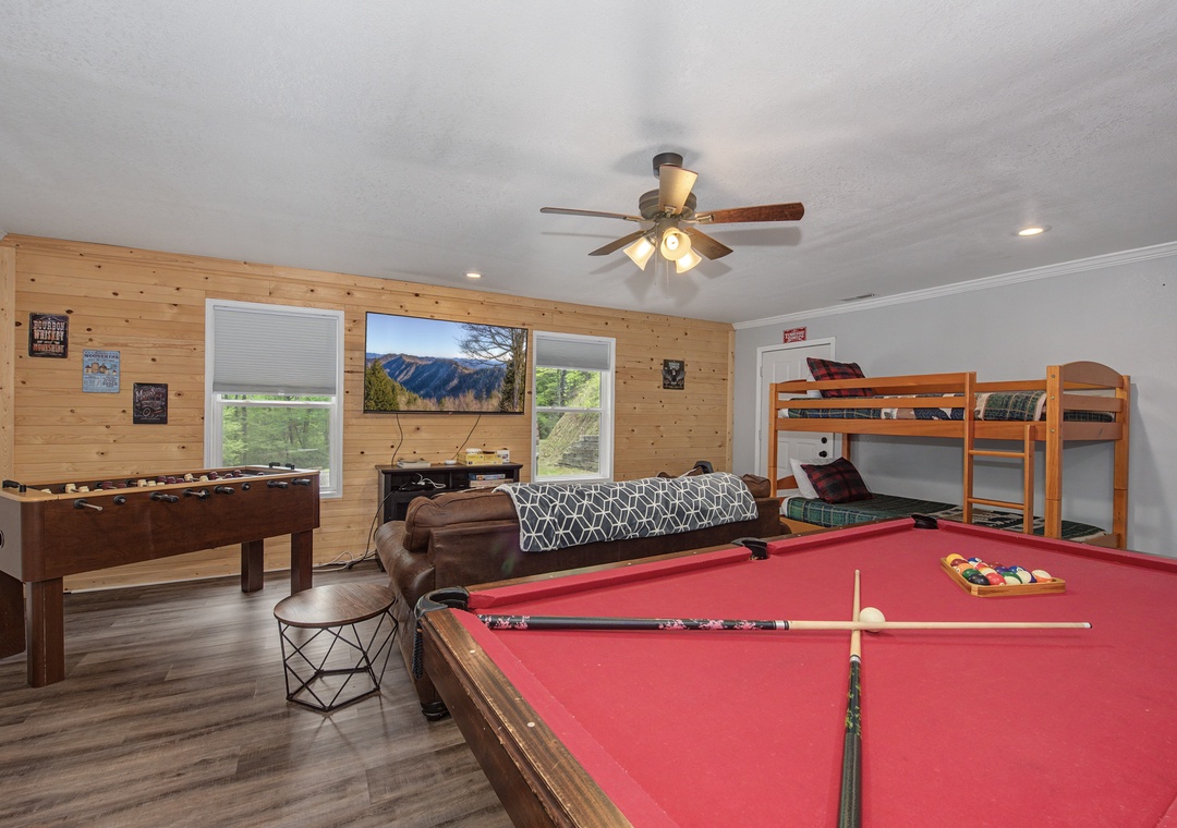 Your game room awaits with pool table, foosball, bunk beds, and mountain views for endless entertainment.