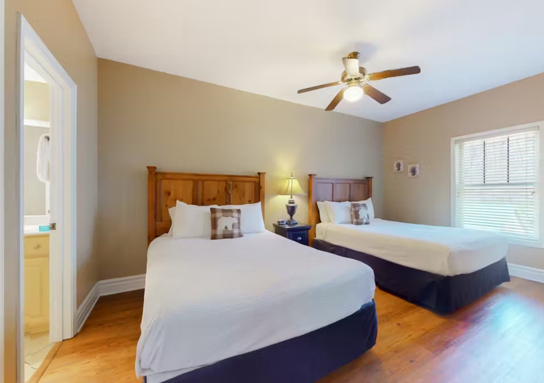 Rest peacefully in your twin bed sanctuary with crisp linens and warm wood accents creating the perfect retreat.