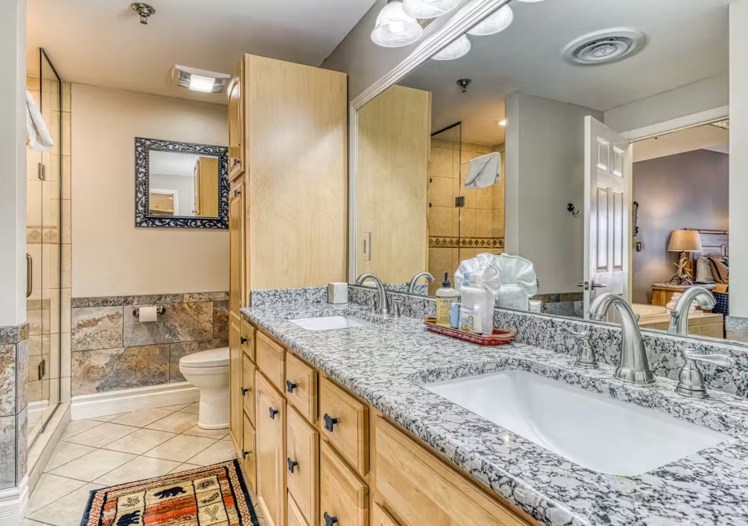 Luxurious granite countertops and elegant fixtures create your perfect retreat for morning routines and evening relaxation.