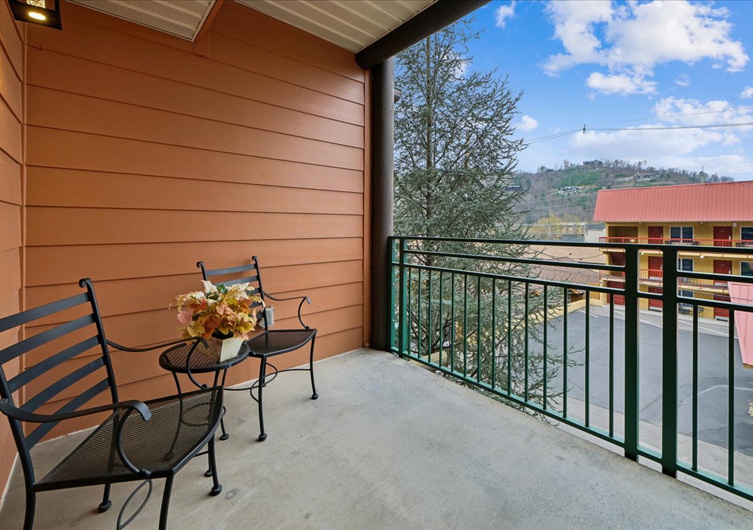 Enjoy your morning coffee on this peaceful balcony overlooking rolling hills and charming neighborhood rooftops.