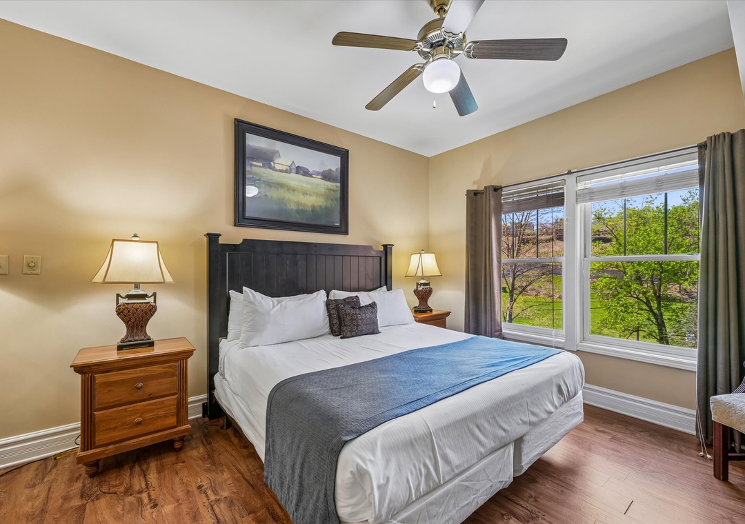 Rest peacefully in your comfortable bedroom with crisp linens, warm lighting, and garden views through the large window.
