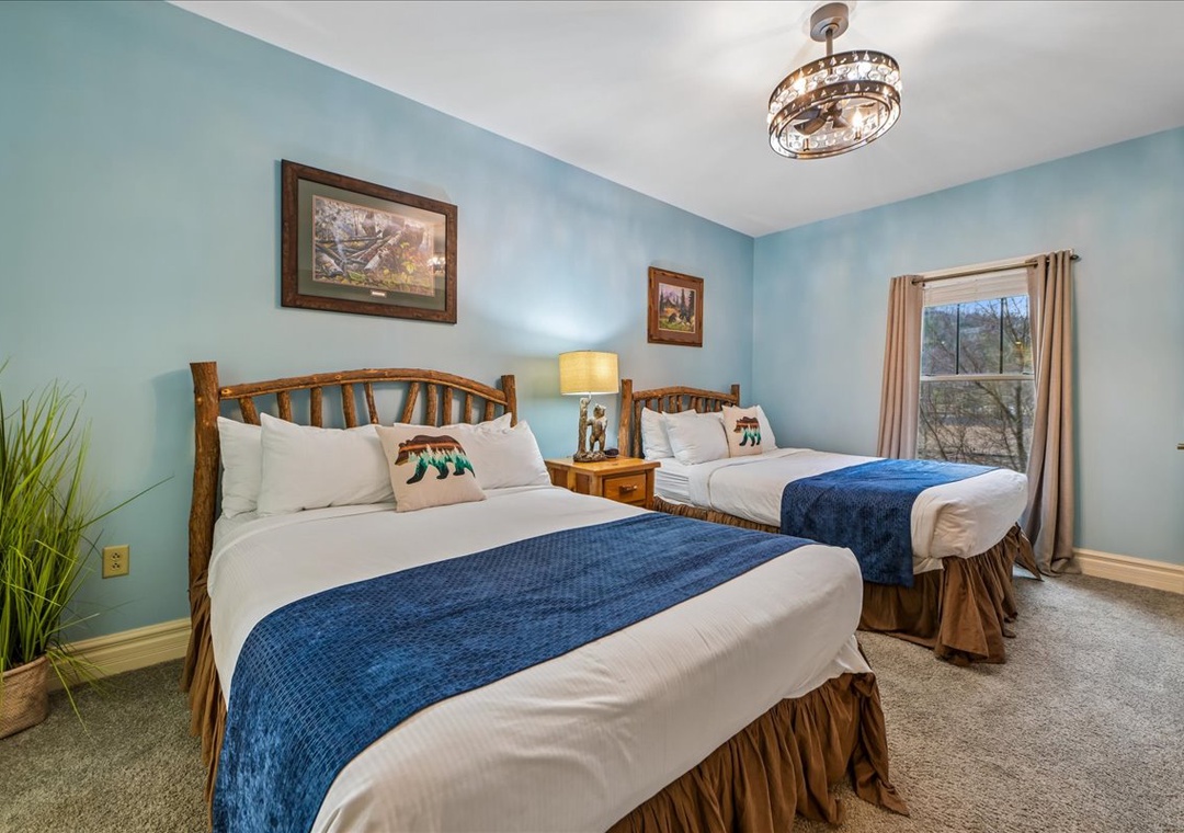 Drift into peaceful dreams in your twin-bed retreat, where soothing blue walls and rustic wood create perfect harmony for restful nights.