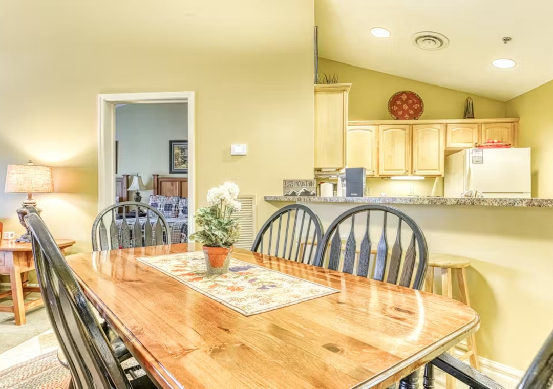 Gather around this welcoming dining table where your meals become memories, with an open kitchen ready for your culinary adventures.