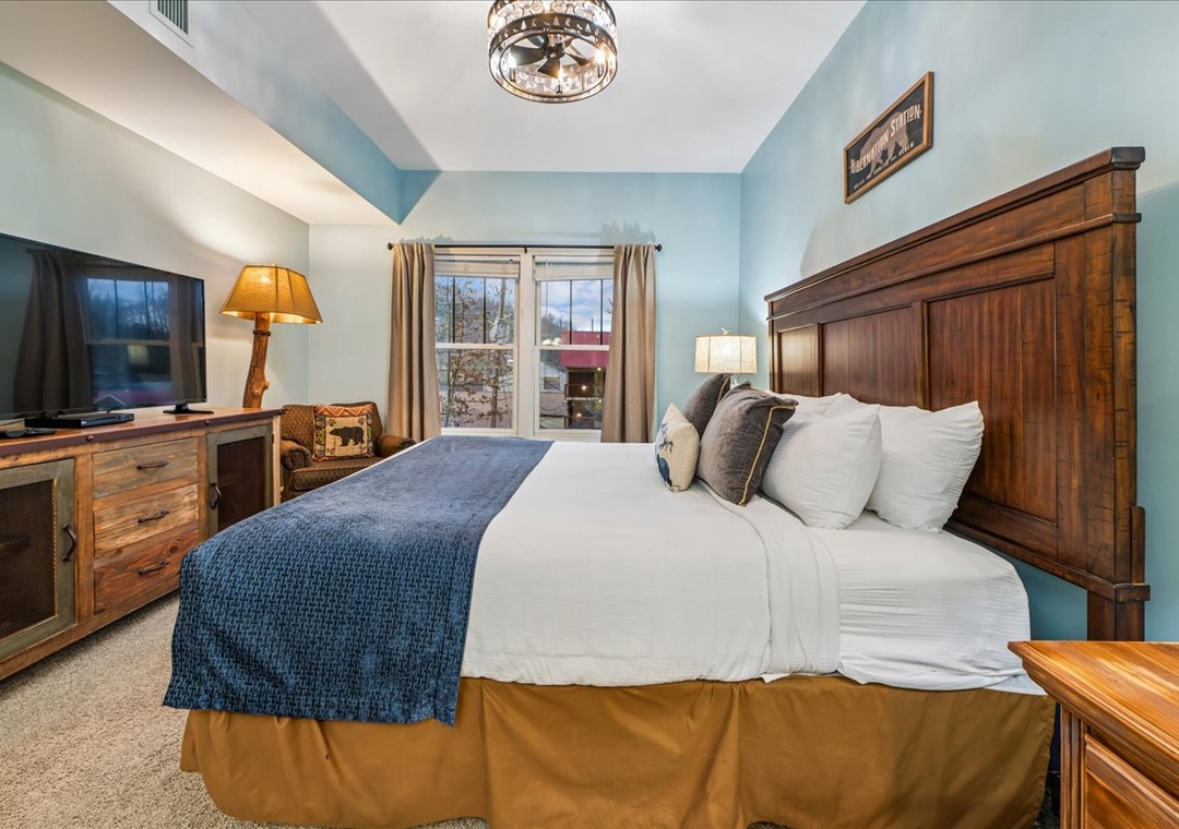 Sink into plush bedding surrounded by warm wood furnishings and soothing blue walls in your peaceful retreat.