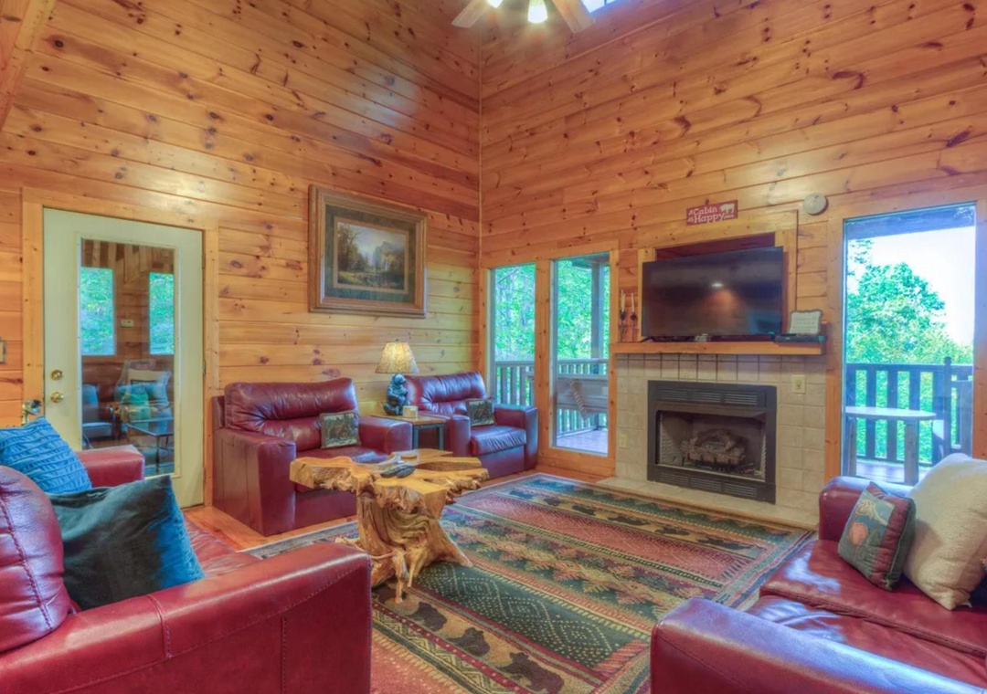 Unwind in your private cabin retreat with warm knotted pine, cozy leather seating, a crackling fireplace, and scenic views through glass doors opening to your balcony.