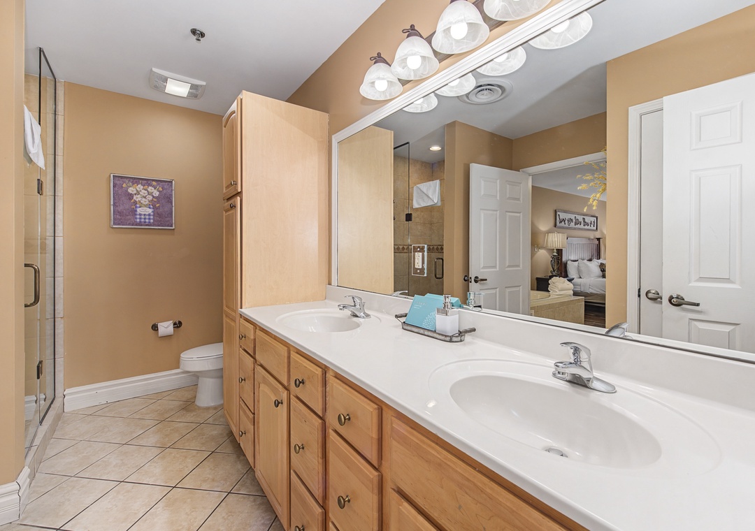 Your spacious master bathroom features dual sinks and warm wood finishes, creating a spa-like retreat for your morning and evening routines.