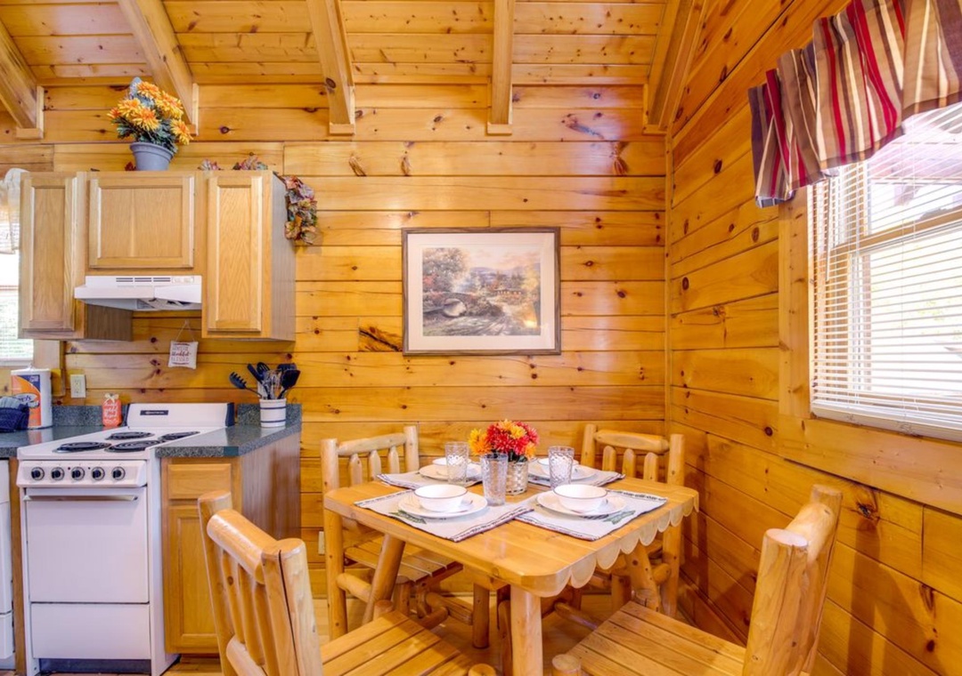 You'll love preparing meals in this charming log cabin kitchen, where warm wood surrounds you and rustic dining awaits.