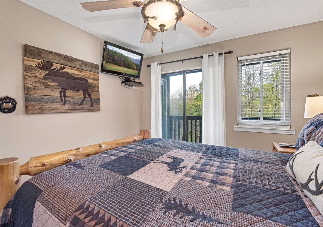 Wake up in this cozy cabin-style bedroom with rustic wood furnishings and mountain wildlife decor creating your perfect retreat.
