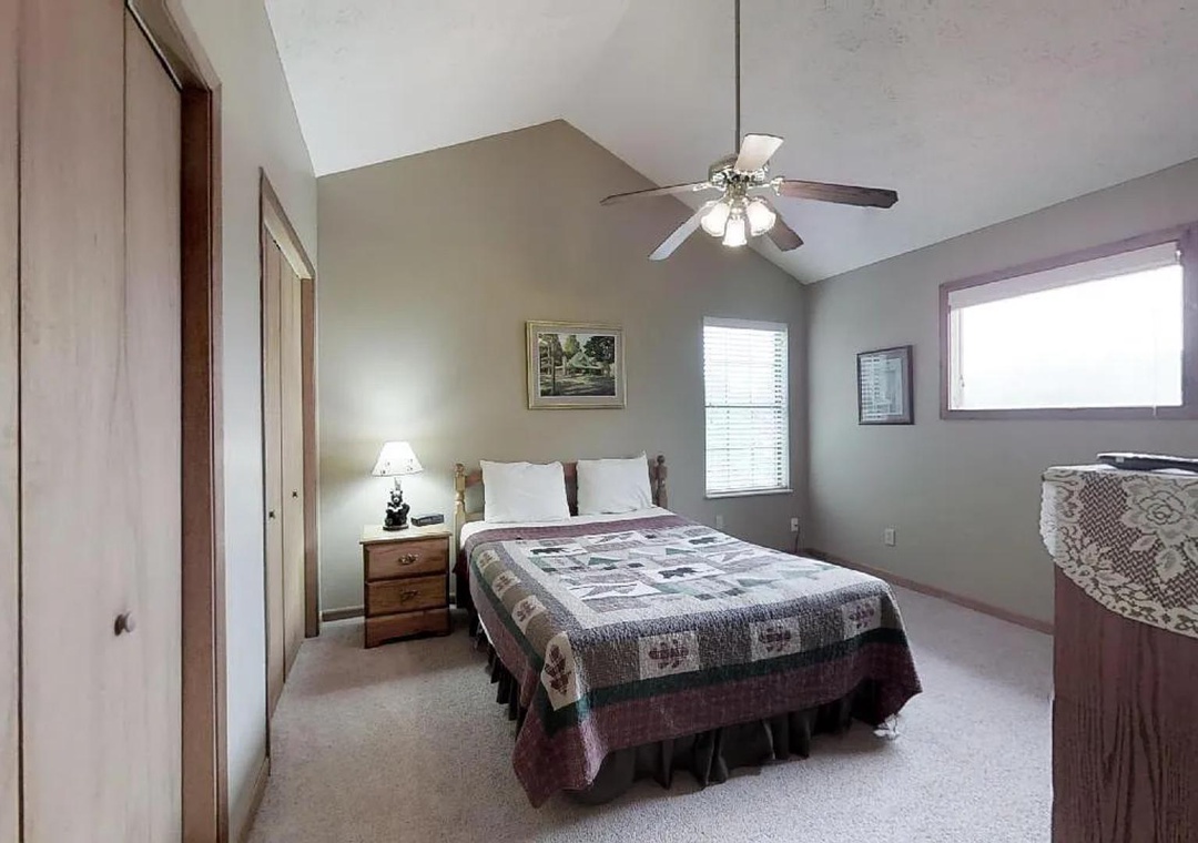 Your peaceful retreat features vaulted ceilings, a ceiling fan for comfort, and soft natural light streaming through bright windows—perfect for restful nights and easy mornings.