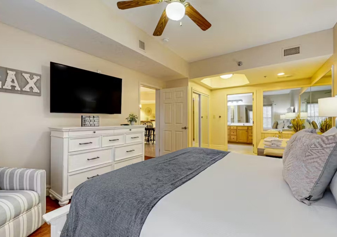 Rest easy in your spacious master suite featuring a ceiling fan, flat-screen TV, and private bathroom.
