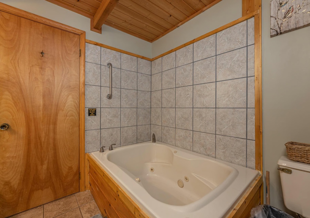 Unwind in your private jetted tub after a day of adventure. The warm wood accents and spacious tile surround create a soothing retreat for relaxation.
