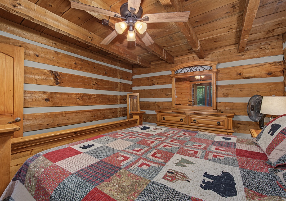 Settle into your cozy log cabin bedroom, where rustic wood beams and warm accents create the perfect retreat after a day of adventure.