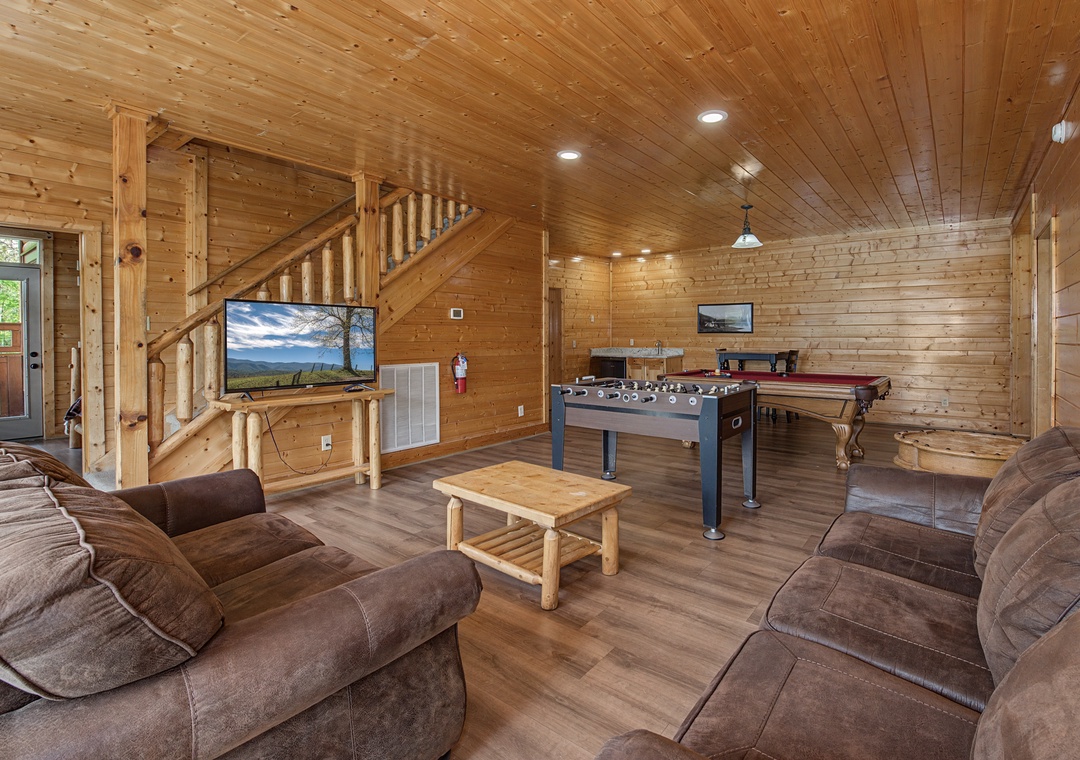 Your rustic game room beckons with pool table, foosball, and cozy seating where you'll create lasting memories.