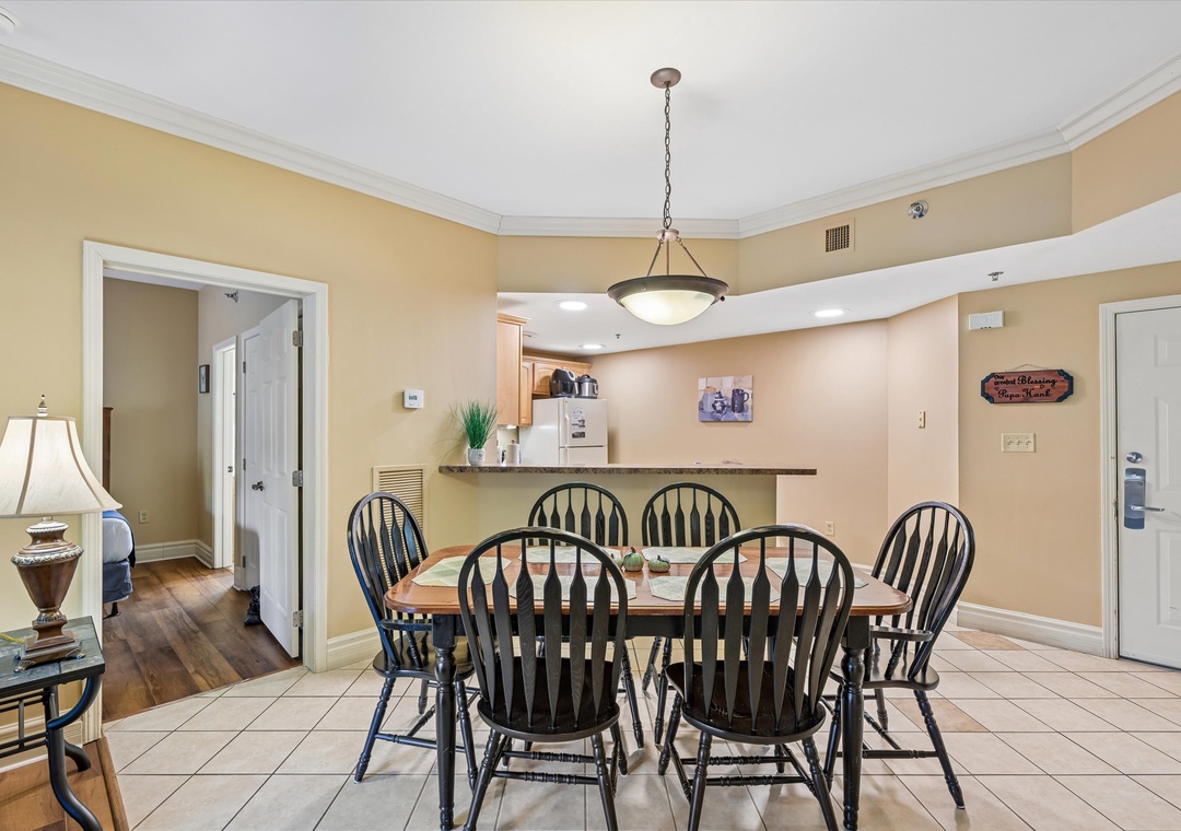 Gather around your spacious dining table for six, where warm lighting creates the perfect atmosphere for family meals and evening conversations.