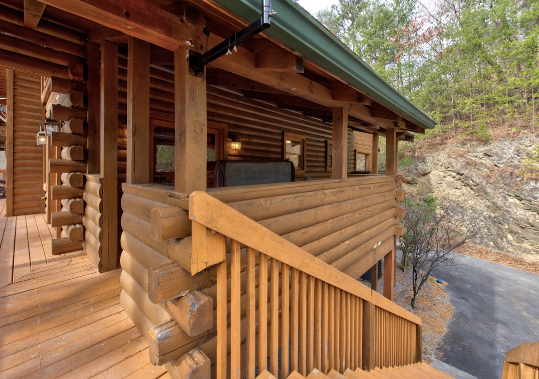 A rustic log cabin nestled among trees and rock formations, featuring traditional wood construction and natural forest surroundings.