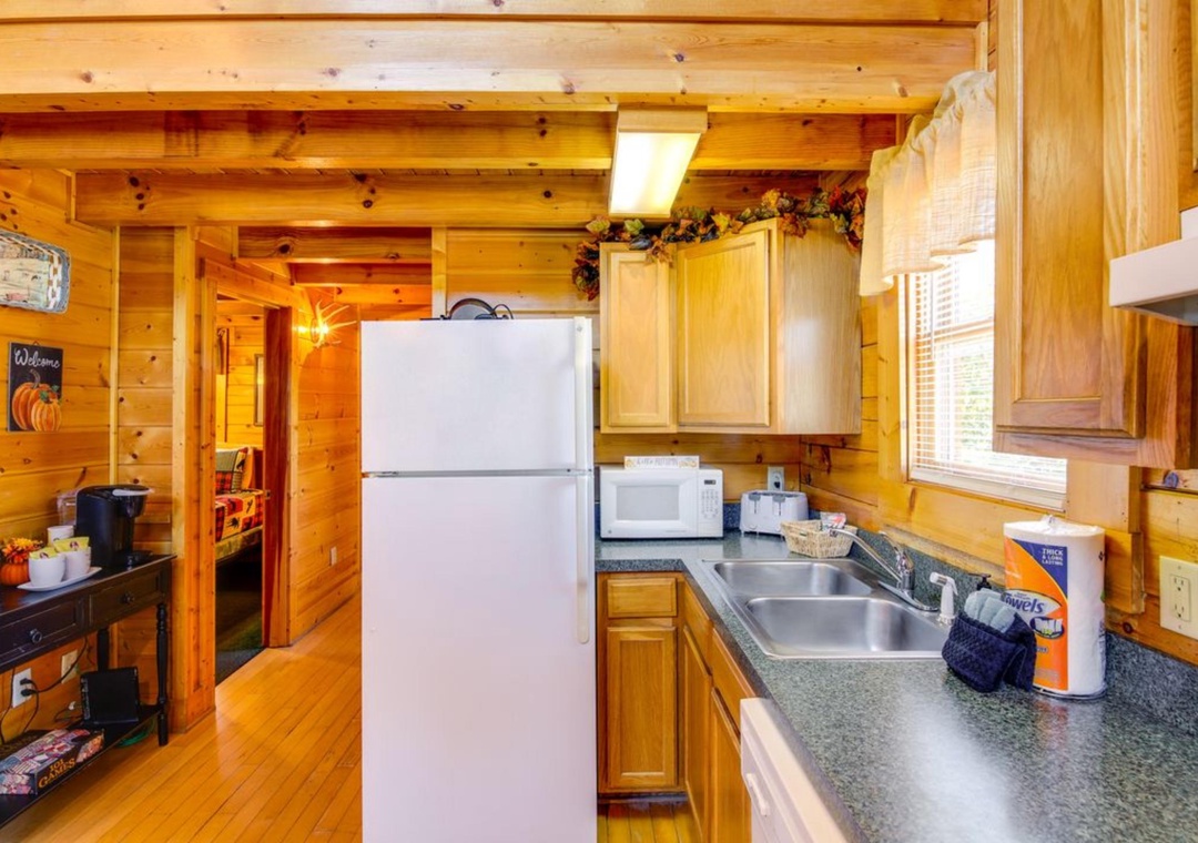 Your cozy cabin kitchen welcomes you with warm wood beams, granite counters, and everything needed to create memorable mountain meals together.