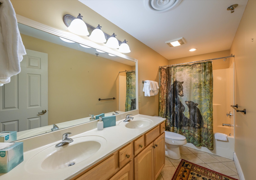 Refresh in your spacious bathroom with dual sinks, nature-themed decor, and plenty of storage for your vacation essentials.