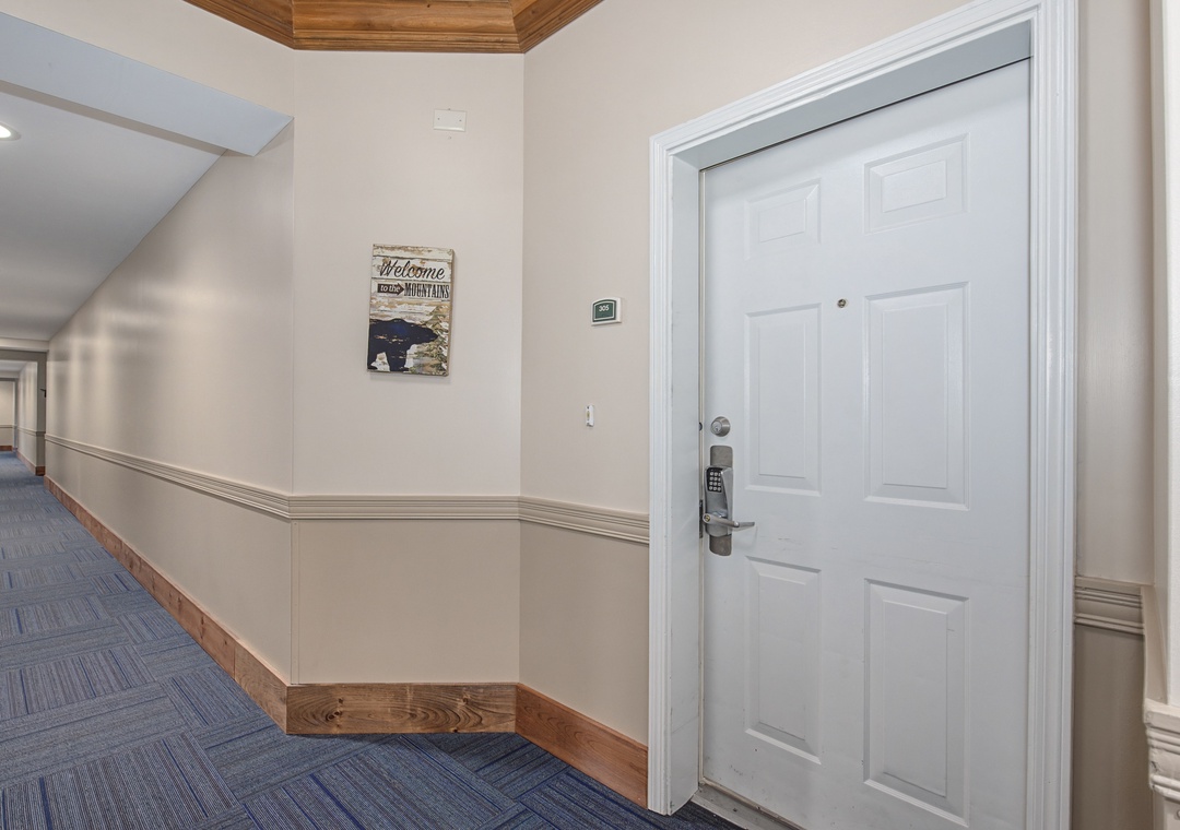 Your private retreat awaits behind this secure door. Step into comfort with electronic keypad entry and elegant wood-accented hallways welcoming you home.