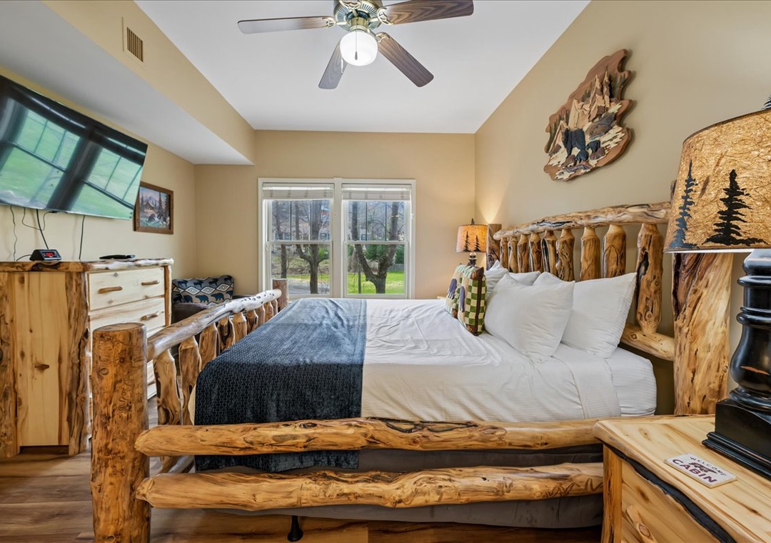 Your rustic bedroom features handcrafted log furniture and crisp linens, creating a cozy mountain retreat atmosphere.