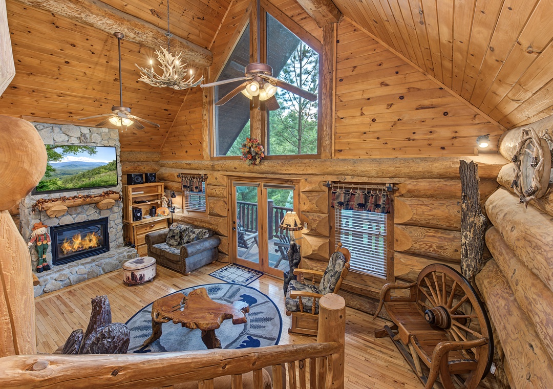 Step into rustic mountain charm with soaring log-beam ceilings, a cozy stone fireplace, and unique handcrafted furnishings that invite you to unwind in nature's embrace.