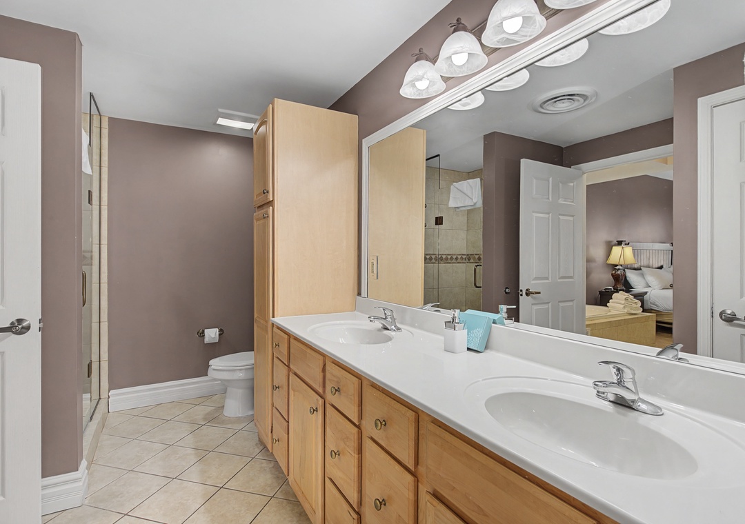 Unwind in your spacious ensuite with dual vanities, ample storage, and natural light streaming through elegant fixtures.
