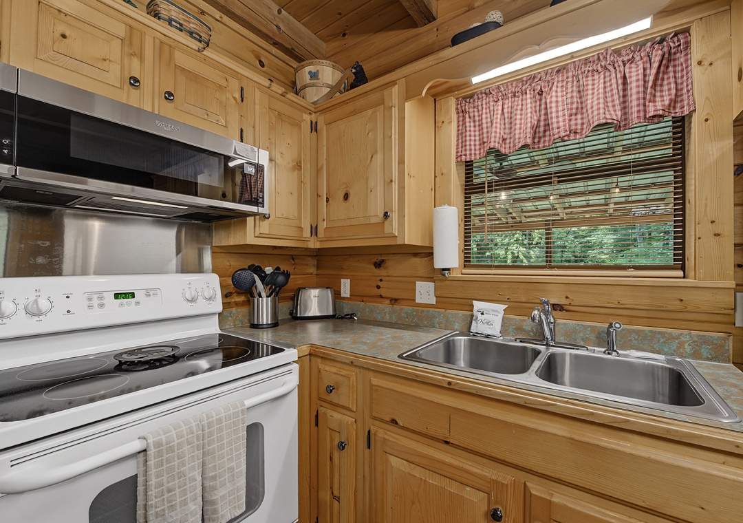 Your fully equipped kitchen features warm pine cabinetry, modern appliances, and everything you need to prepare delicious home-cooked meals during your stay.