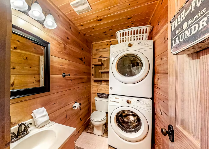 Your cozy cabin bathroom combines rustic charm with modern convenience, featuring full laundry facilities alongside your private bath.