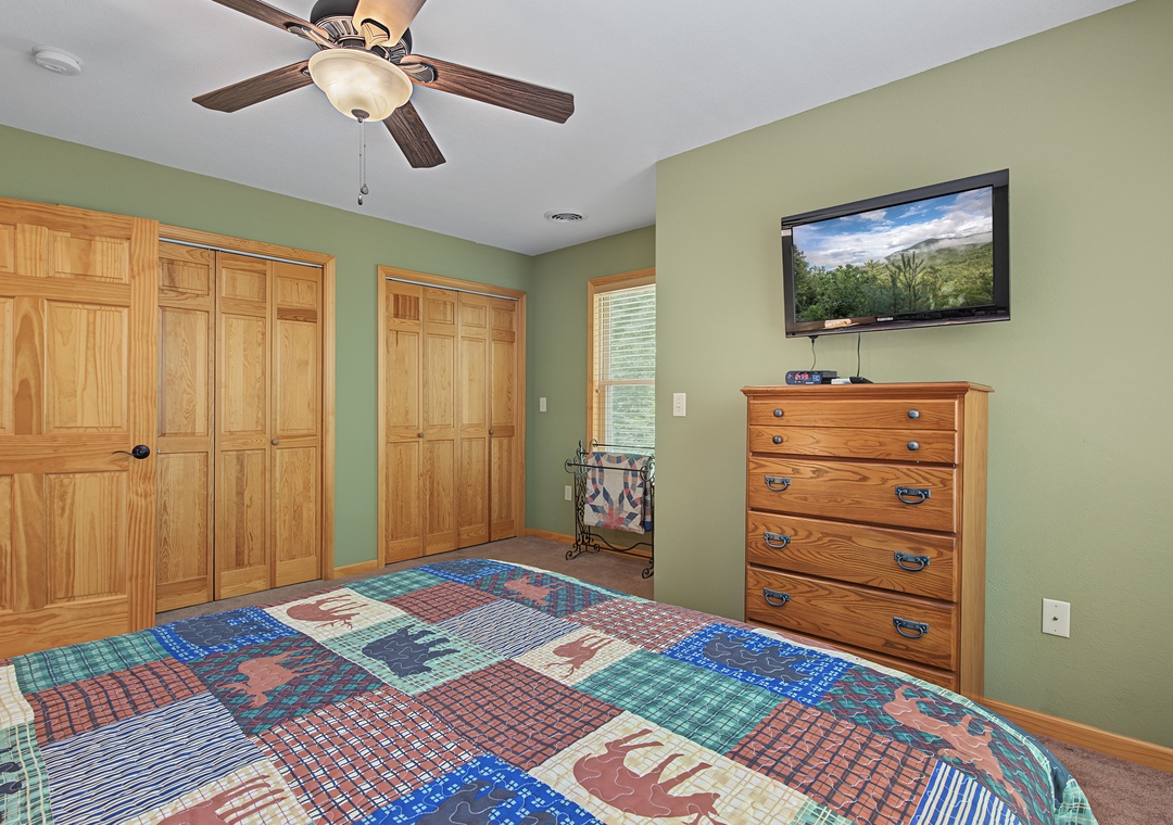 Relax in your private bedroom with a plush bed, ceiling fan, and flat-screen TV. Wake up to natural light streaming through the window and store your belongings in the spacious dresser and closet.