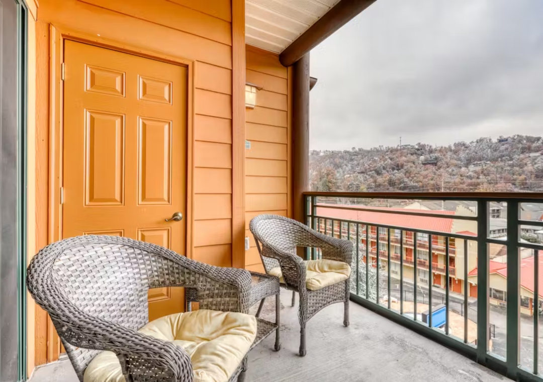 Relax in your private balcony with comfortable wicker chairs while enjoying views of the surrounding hills and neighborhood below.