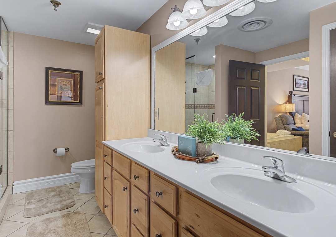 Your spacious bathroom features dual sinks and ample storage, perfect for getting ready together each morning.