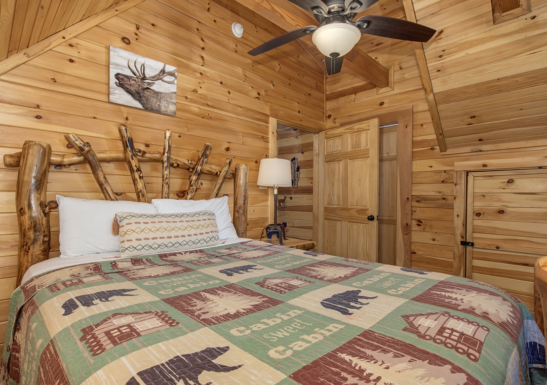 Drift off in this cozy cabin bedroom, where rustic wood walls and a handcrafted branch headboard surround your comfortable bed. The nature-inspired décor and soft bedding create a peaceful mountain retreat just for you.