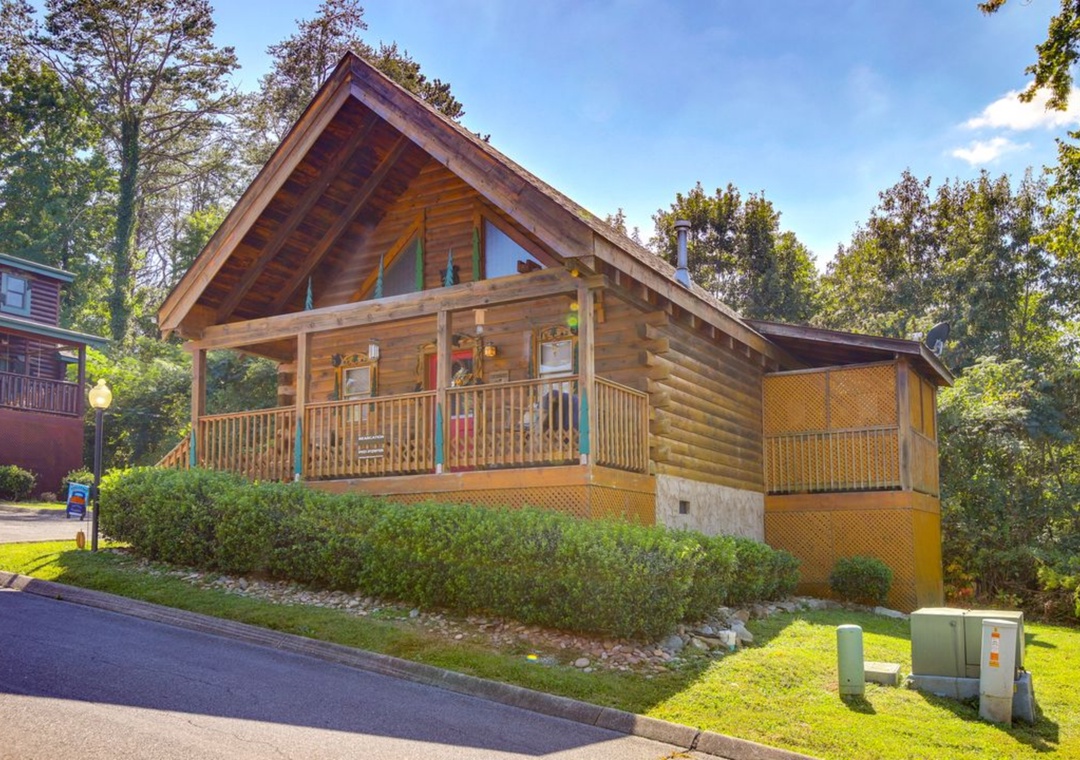 Charming log cabin nestled among trees with covered deck and forest setting for a peaceful woodland retreat.