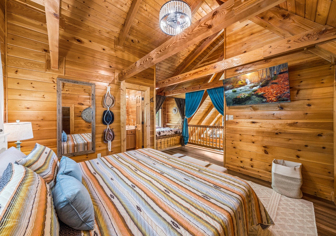 Cozy cabin bedroom with warm wood beams, soft linens, and a touch of rustic charm—your peaceful mountain retreat awaits.