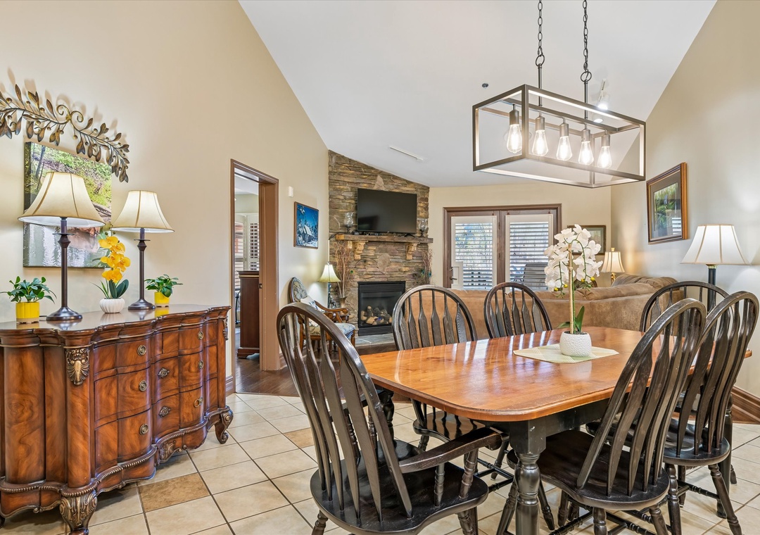 Gather around this elegant dining table where memorable meals await. The cozy fireplace creates perfect ambiance for your group dinners.