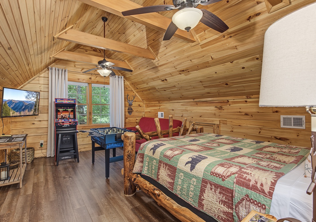 Your cozy mountain retreat awaits with vaulted wood ceilings, a comfortable bed dressed in rustic linens, and fun game room touches. Challenge someone to foosball or enjoy the natural light streaming through the windows.