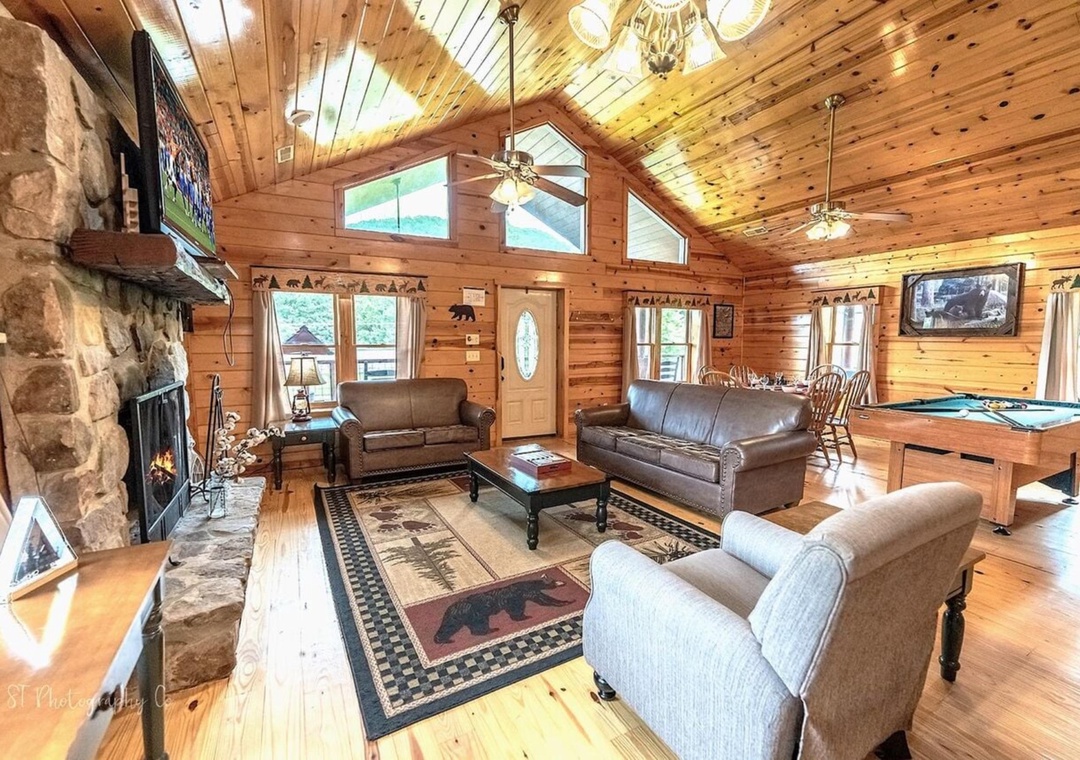 Relax in your spacious living area with soaring vaulted ceilings, cozy stone fireplace, and open flow to the billiards table—perfect for unwinding after a day of adventure.