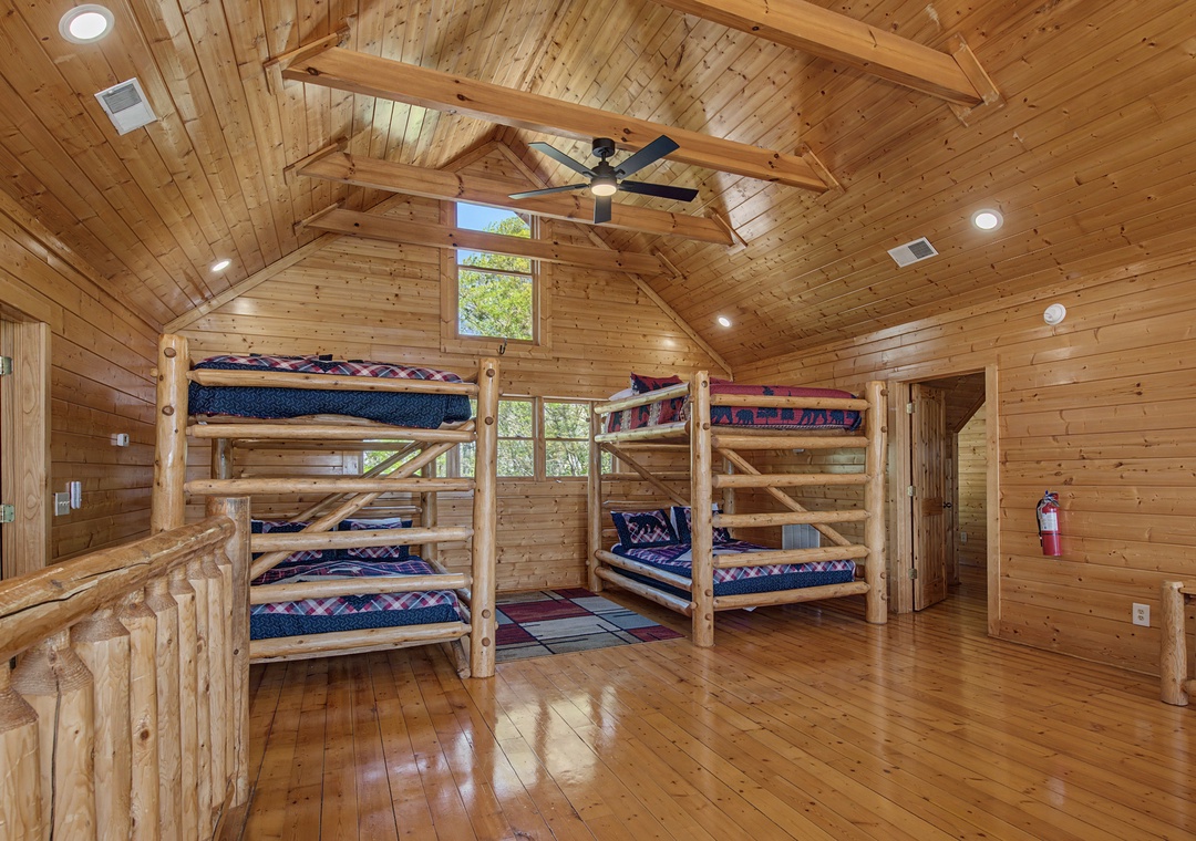 Your rustic cabin bunk room sleeps the whole crew in cozy log-built comfort with soaring ceilings and warm wood everywhere.