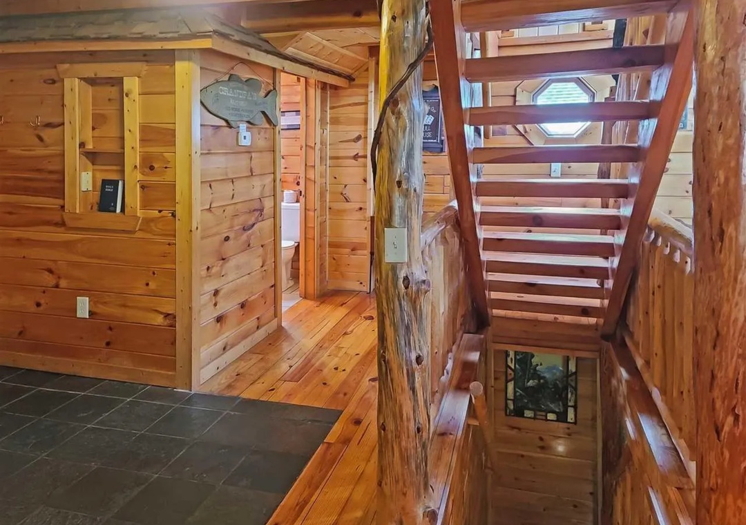 Step into your rustic retreat where rich wood beams and handcrafted railings create a warm, cabin atmosphere perfect for your mountain getaway.