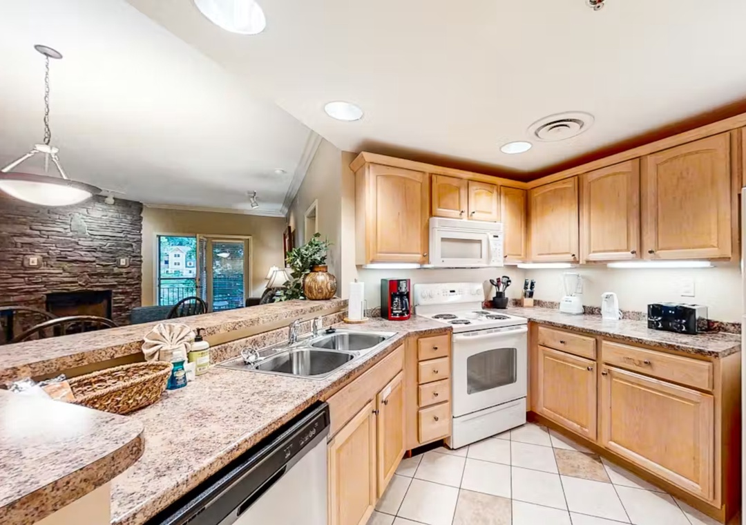 Cook your favorite meals in this fully equipped kitchen with granite countertops, modern appliances, and plenty of prep space for your culinary adventures.