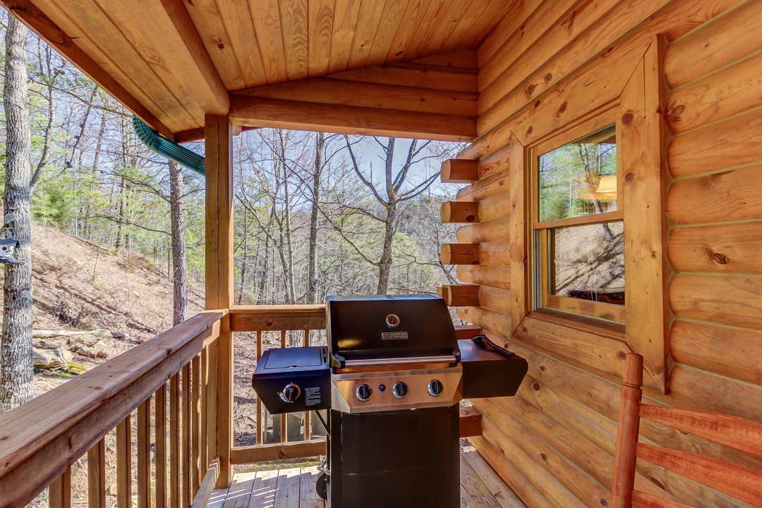 Your private covered deck offers peaceful forest views and a gas grill ready for outdoor cooking—a perfect retreat for morning coffee or evening cookouts.
