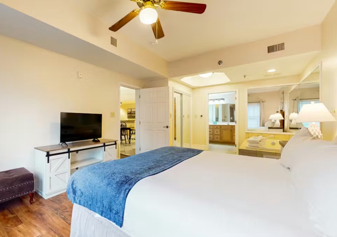 Your spacious bedroom suite offers comfort with crisp linens, entertainment center, and luxurious ensuite bathroom featuring elegant tub.