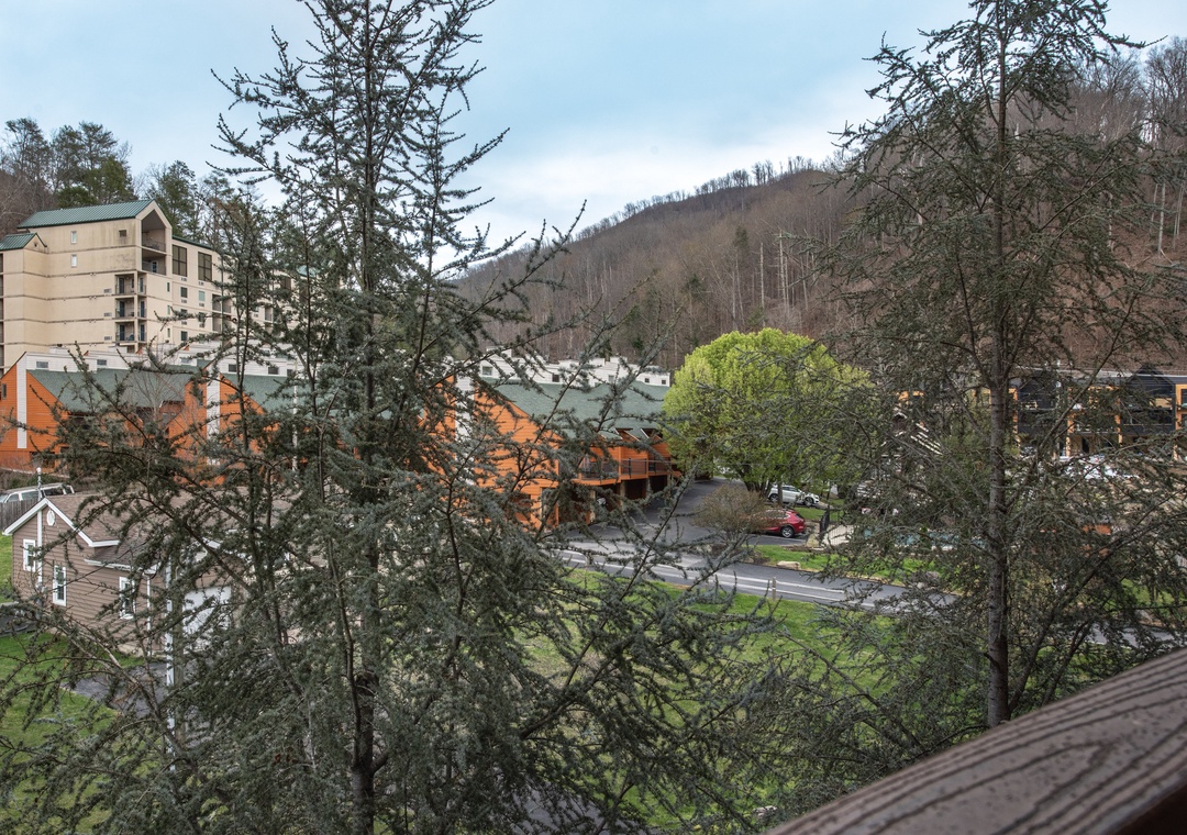 Mountain valley setting with rolling hills and charming village buildings creating a peaceful retreat atmosphere.