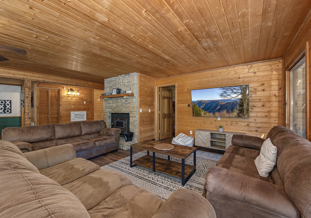 Sink into plush seating surrounded by warm wood finishes. Your mountain view awaits on the big screen, and the stone fireplace adds cozy charm for your evening gatherings.