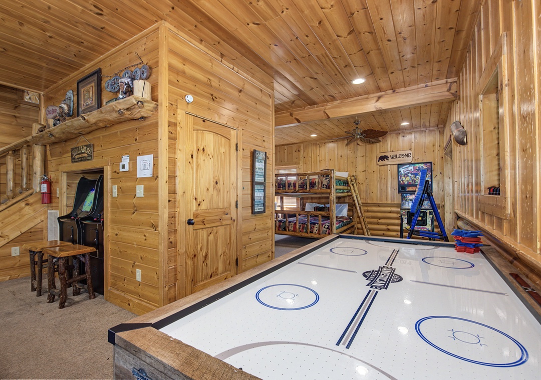 Your private game room awaits with air hockey, arcade games, and rustic charm for endless entertainment.